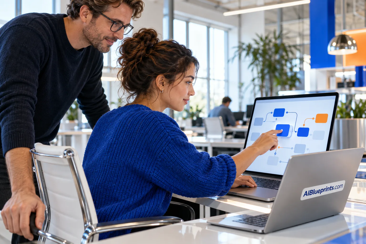 Two colleagues mapping a workflow on a glass wall in a technical studio.
